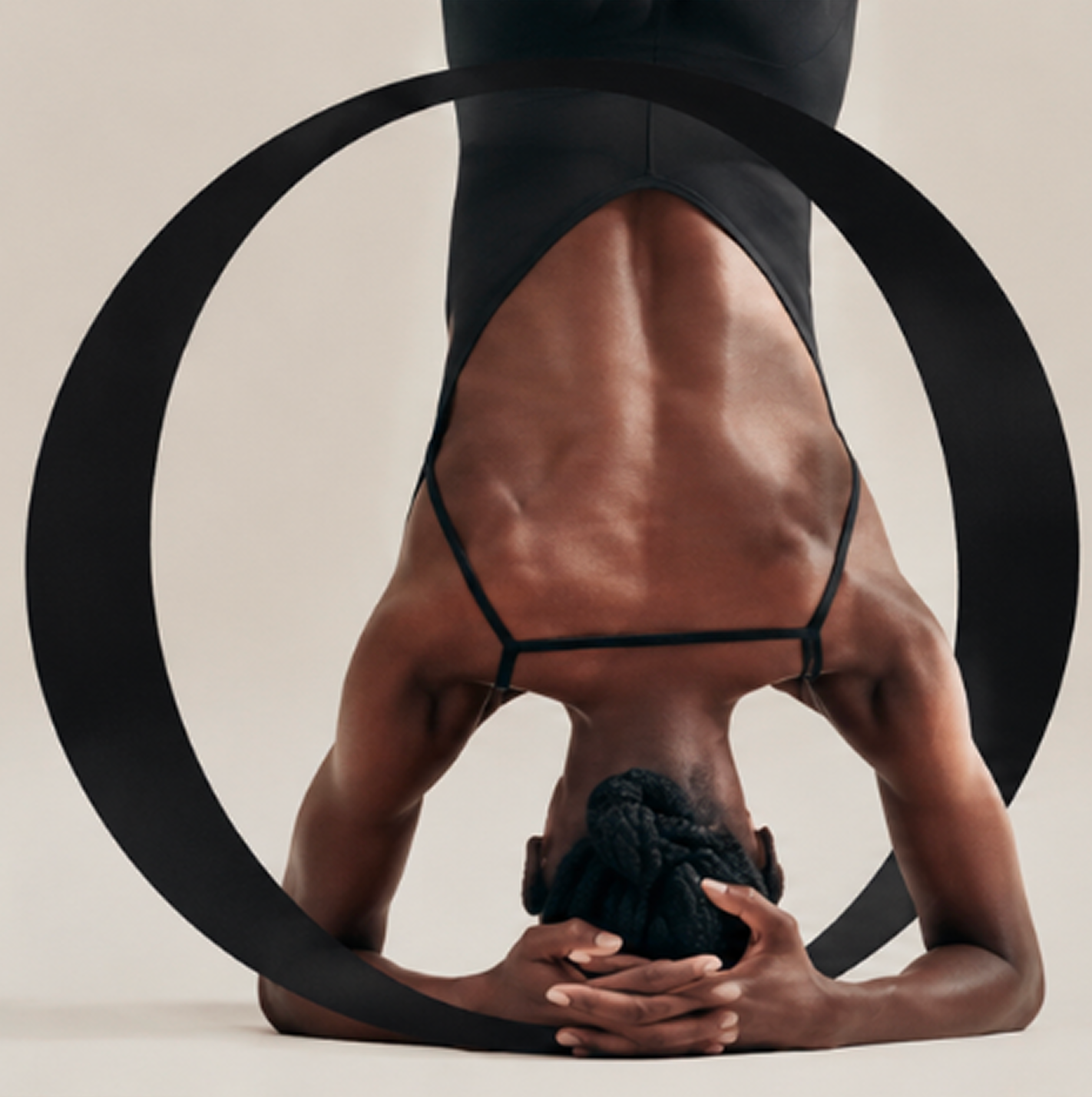 Pilates pose framed by an oversized letter O